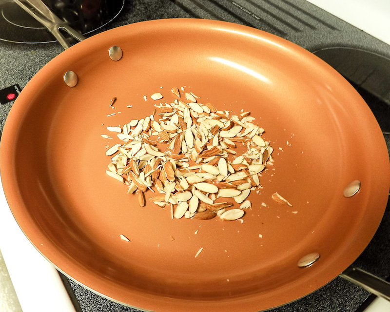 Almonds toasting in skillet | asprinkleandasplash.com