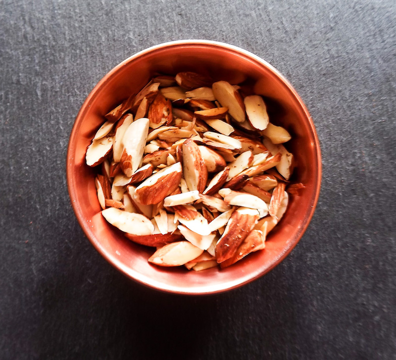 Overhead picture of toasted almonds in copper pinch bowl from Target | asprinkleandasplash.com