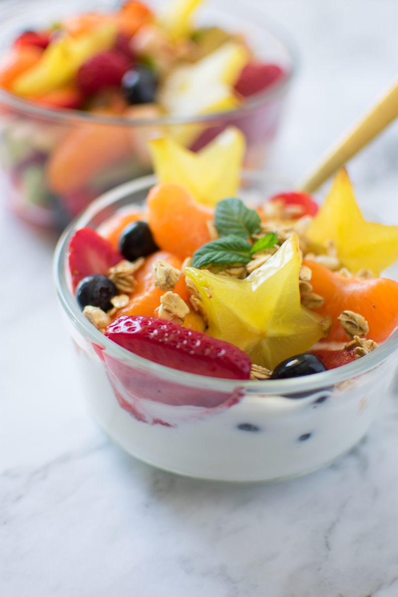 Meal Prep Fruit Salad in a bowl with yogurt and granola close up picture