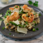 Risotto topped with shrimp on a plate