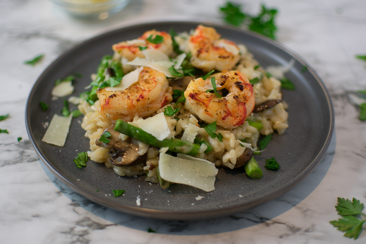 Risotto topped with shrimp on a plate