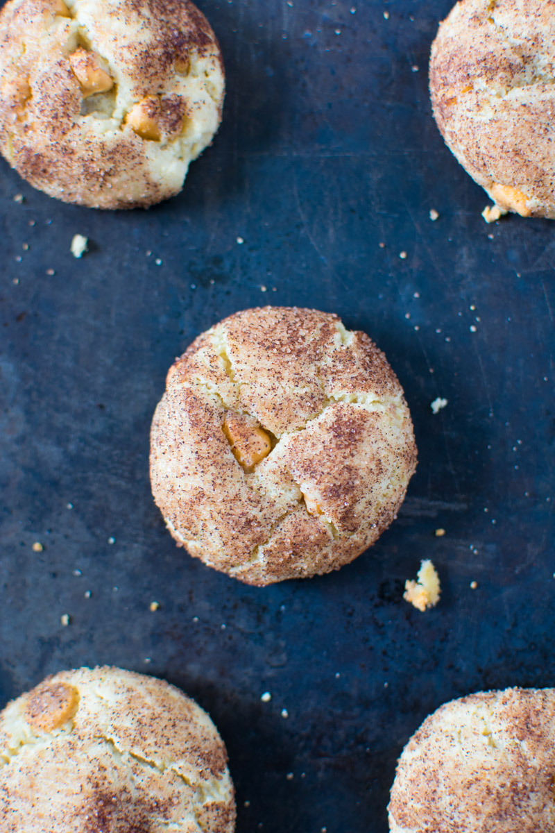 Closeup picture of cookies on a baking sheet with cookie crumbs all around