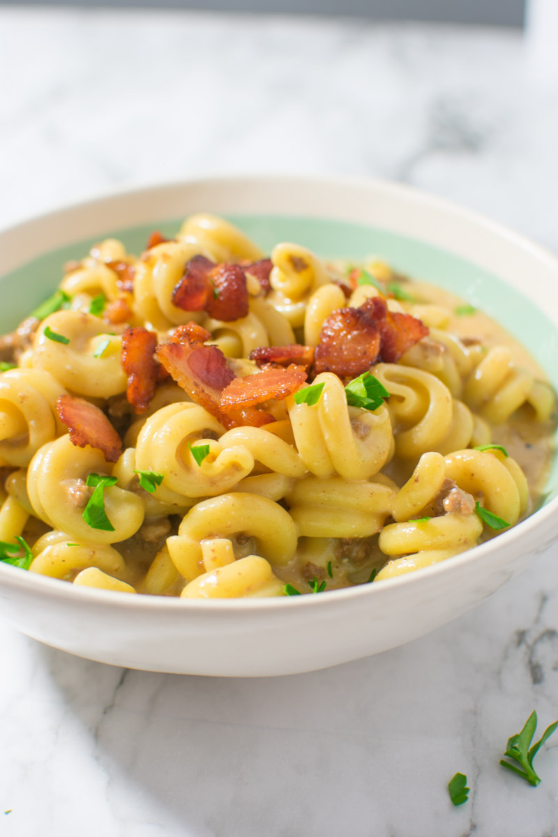Instant Pot Bacon Cheeseburger Pasta in bowl with bacon on top