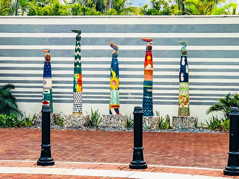 Painted poles with pelicans on top