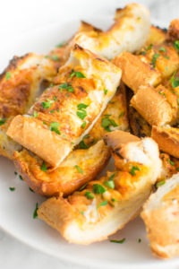 Close up of slices of Cheesy Ranch Garlic Bread on a plate