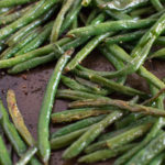 Roasted green beans on a baking sheet