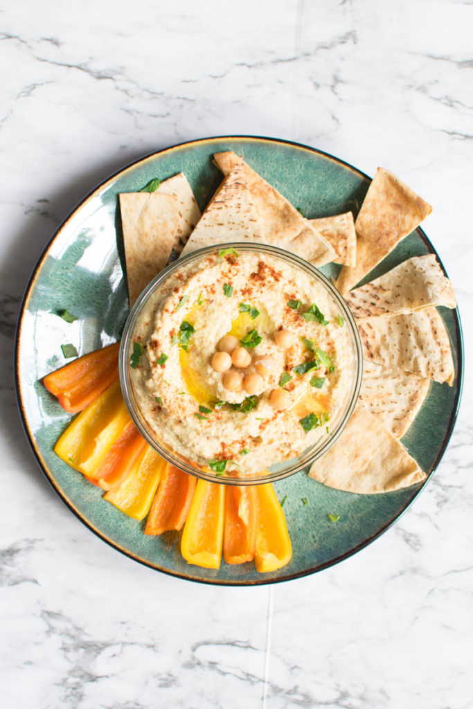 Overhead view of hummus, veggies and pita chips
