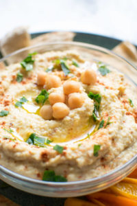 very close up view of hummus with chickpeas on top