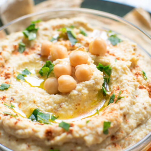 very close up view of hummus with chickpeas on top