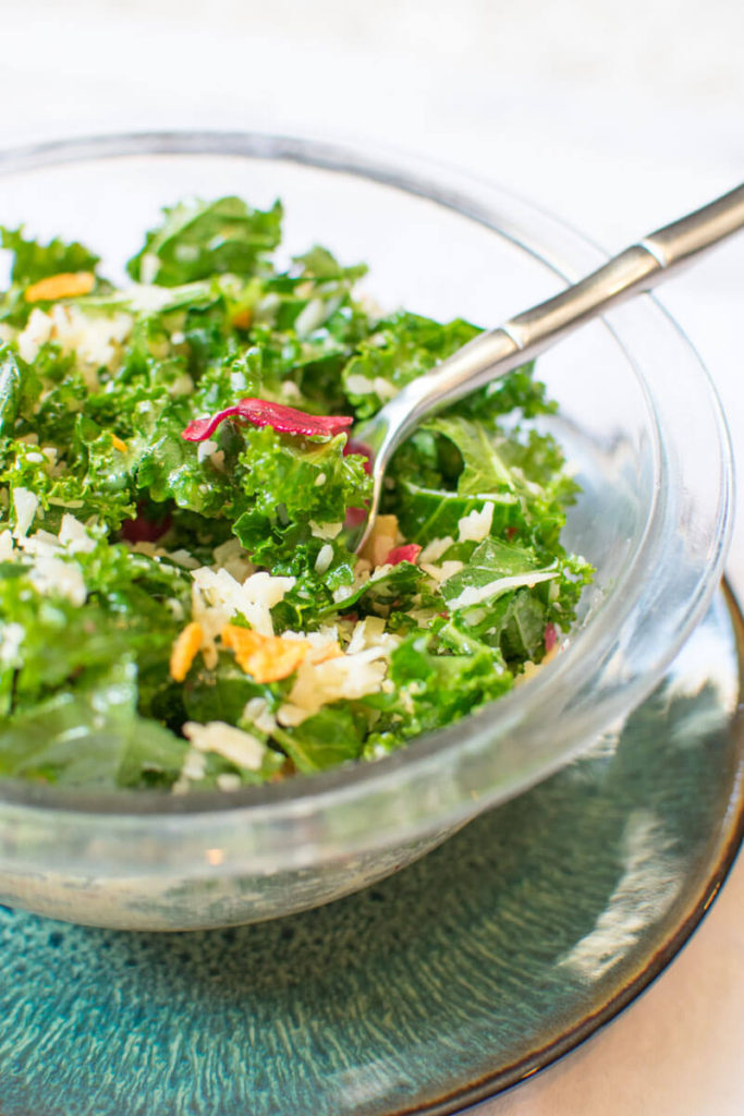 Lemony Raw Kale Salad in a bowl on top of a plate