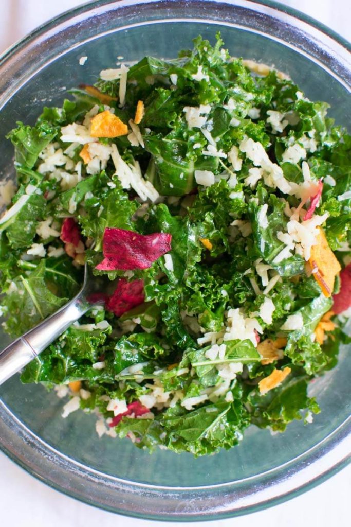 Overhead closeup view of Lemony Raw Kale Salad in a bowl
