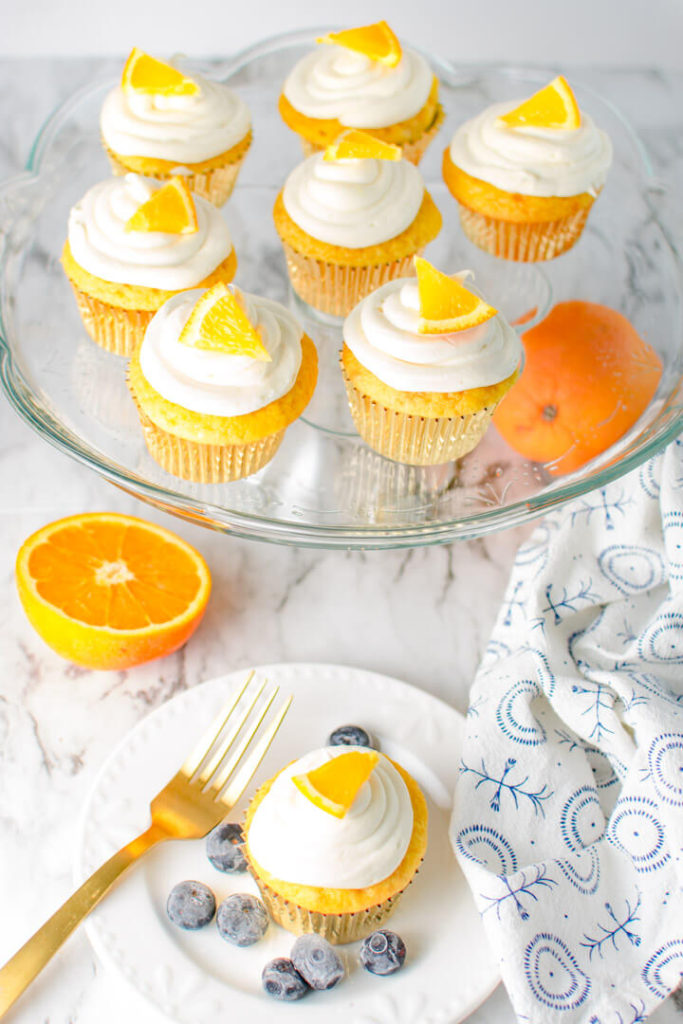 Serving platter of Orange Crunch Cupcakes and one cupcake on a plate