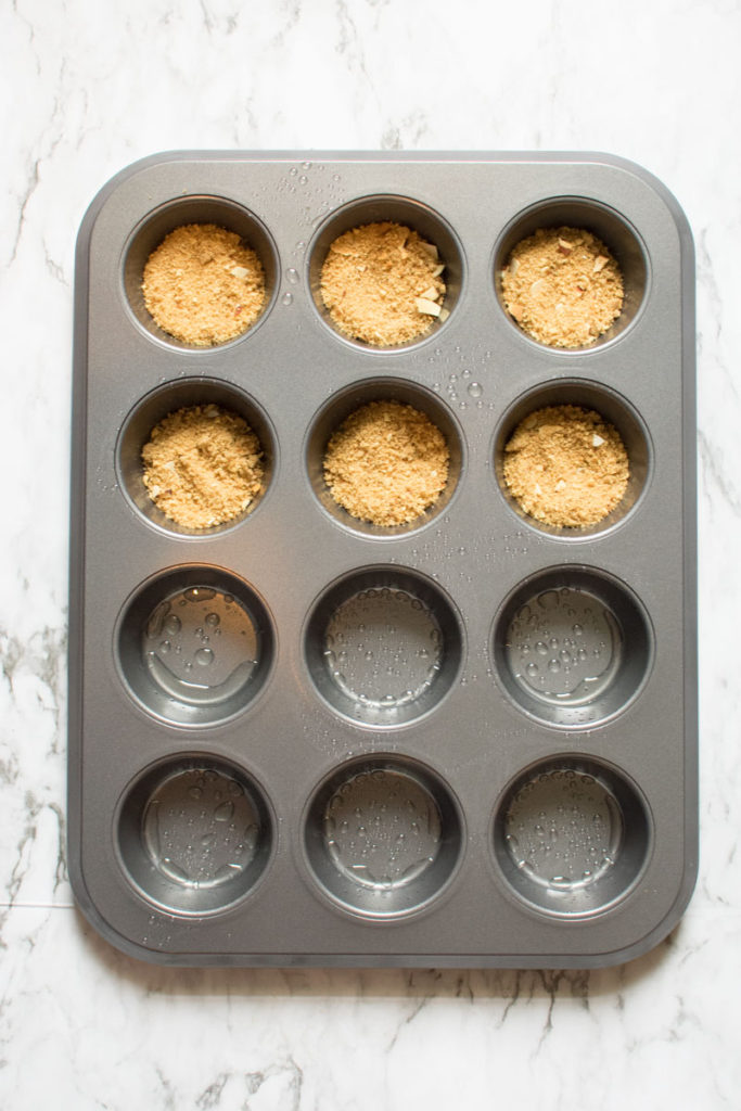 cupcake crust on the bottom is pressed into cupcake pan