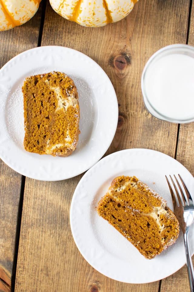 Overhead view of two slices of pumpkin cheesecake bread on plates