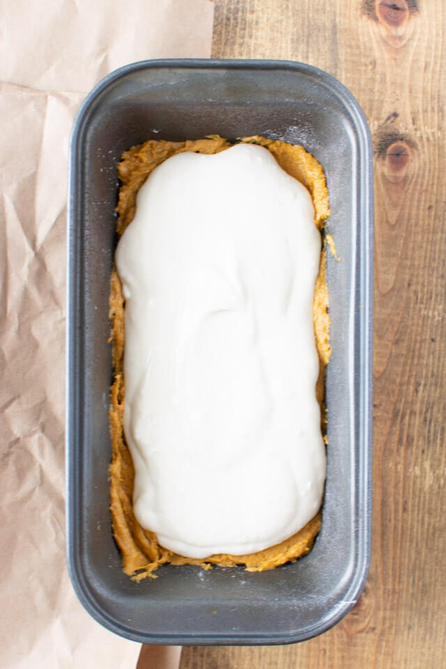 pumpkin batter topped with cheesecake batter in loaf pan