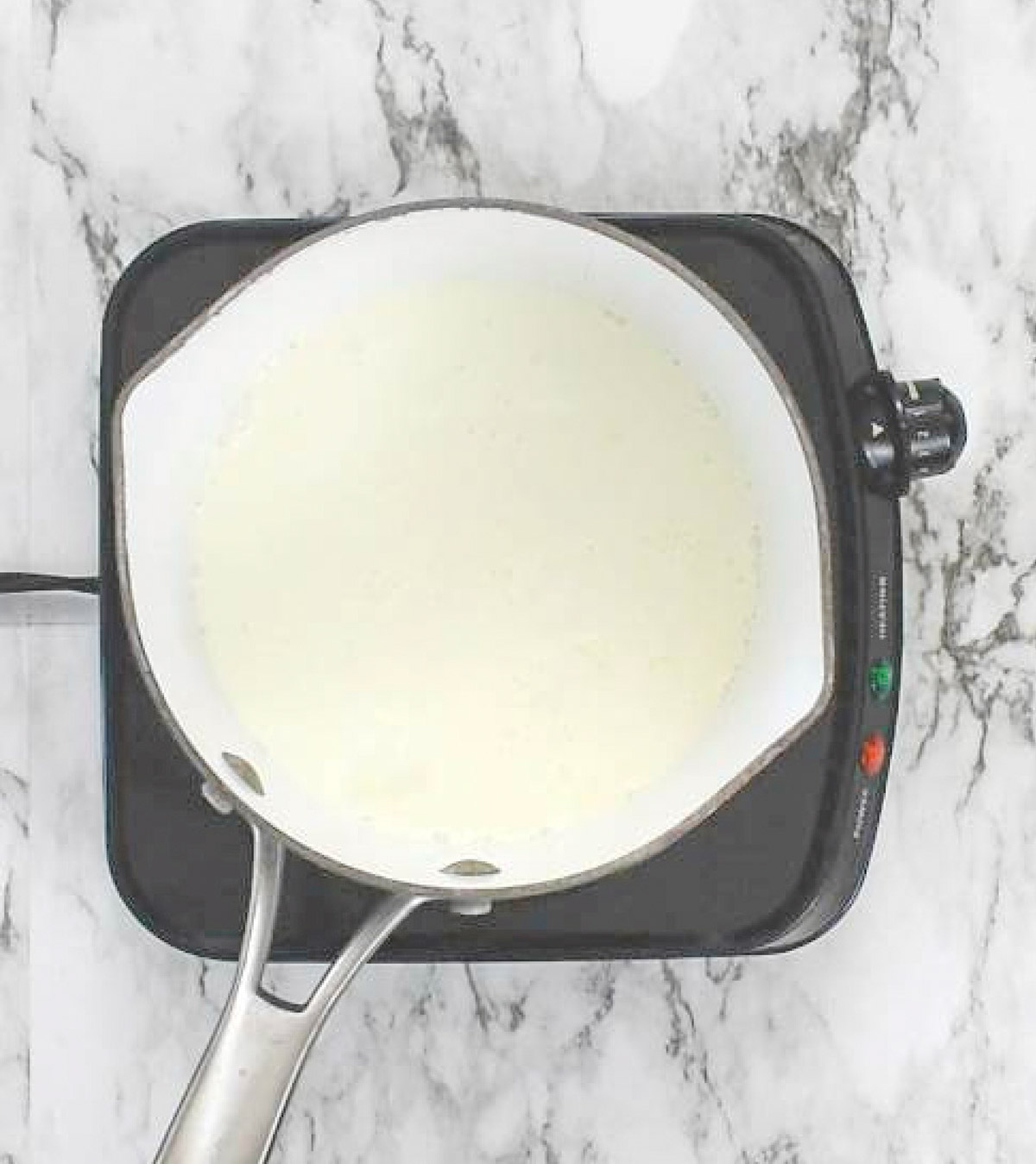Cream heating up in saucepan