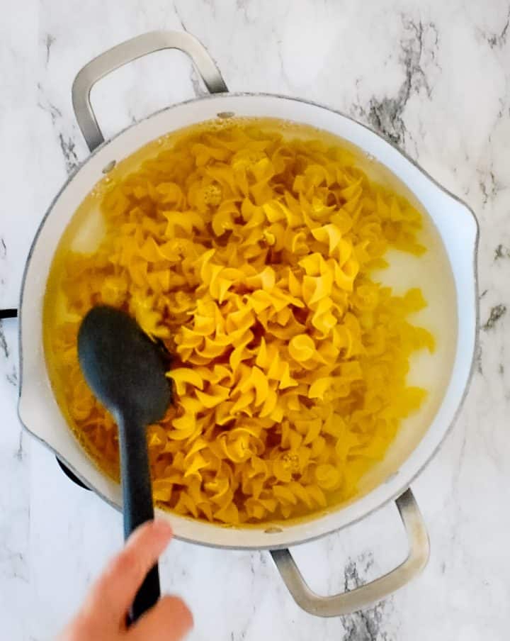 egg noodles cooking in a pot of water