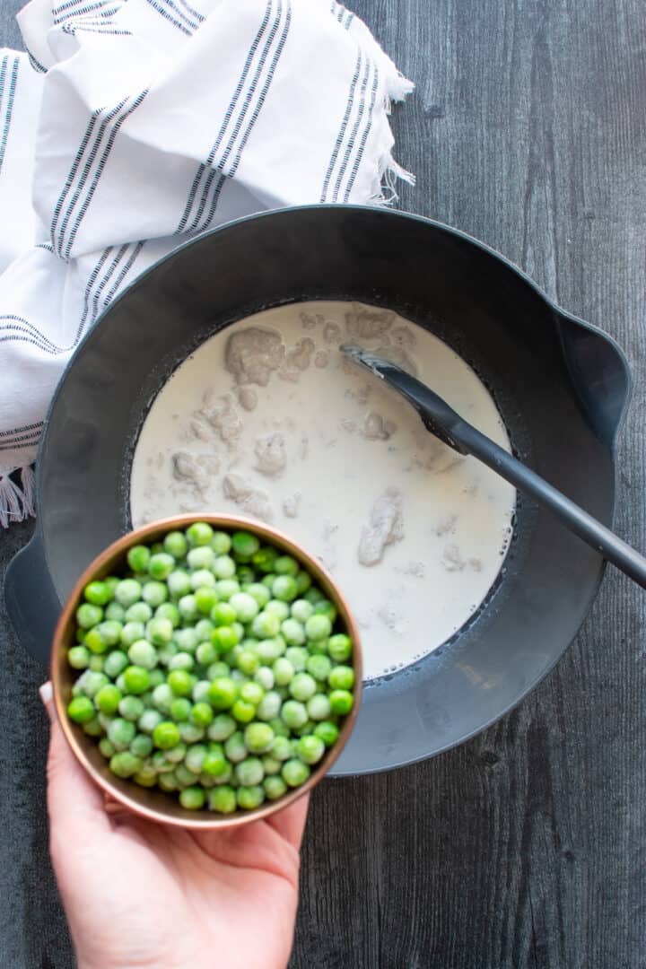 adding peas to mixing bowl