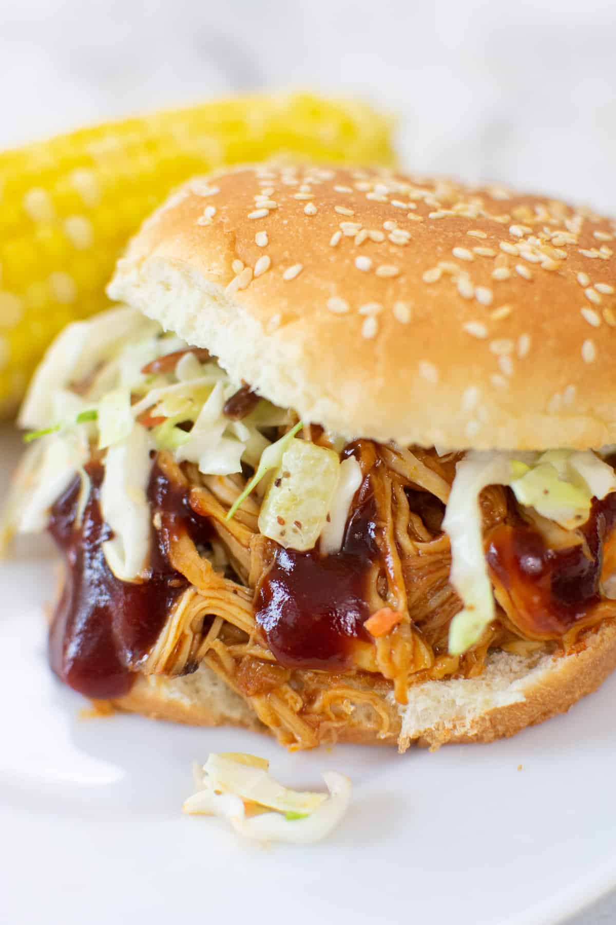 closeup of a bbq chicken sandwich with coleslaw