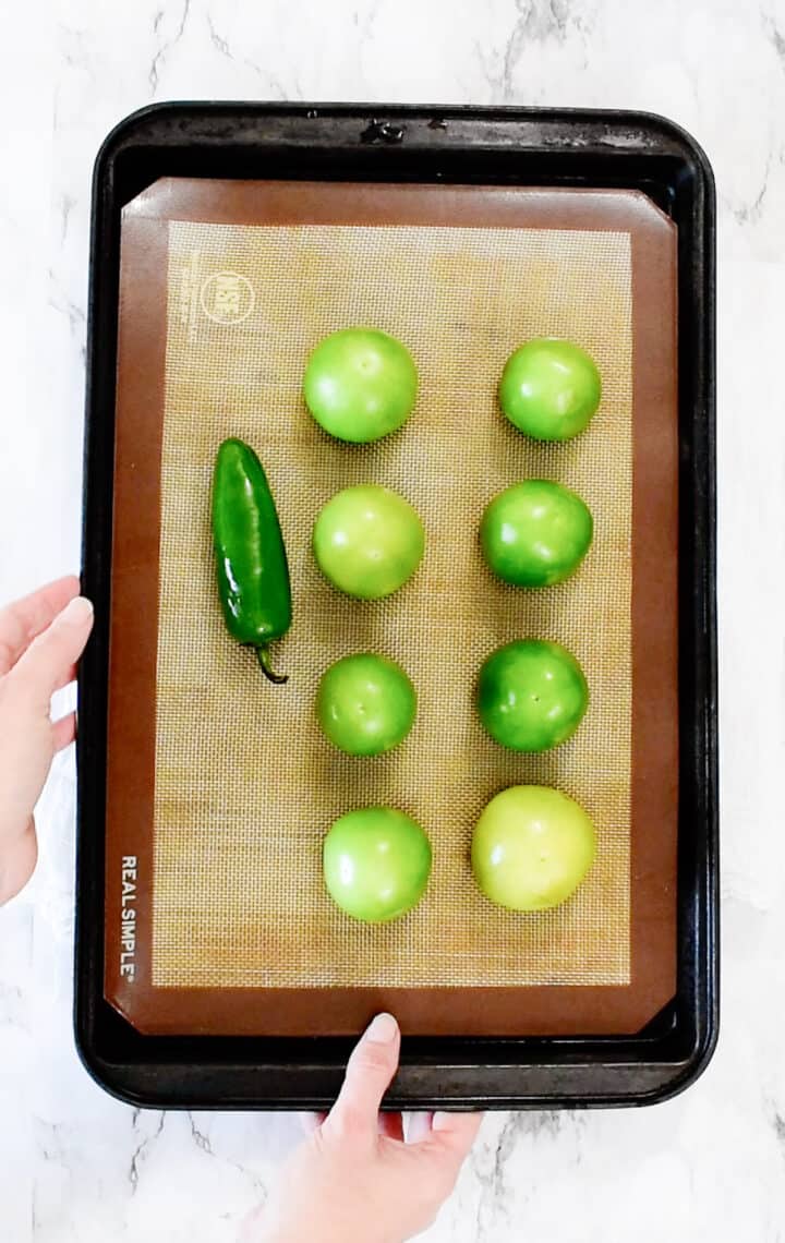 tomatillos and jalapeno on sheet pan ready to be roasted
