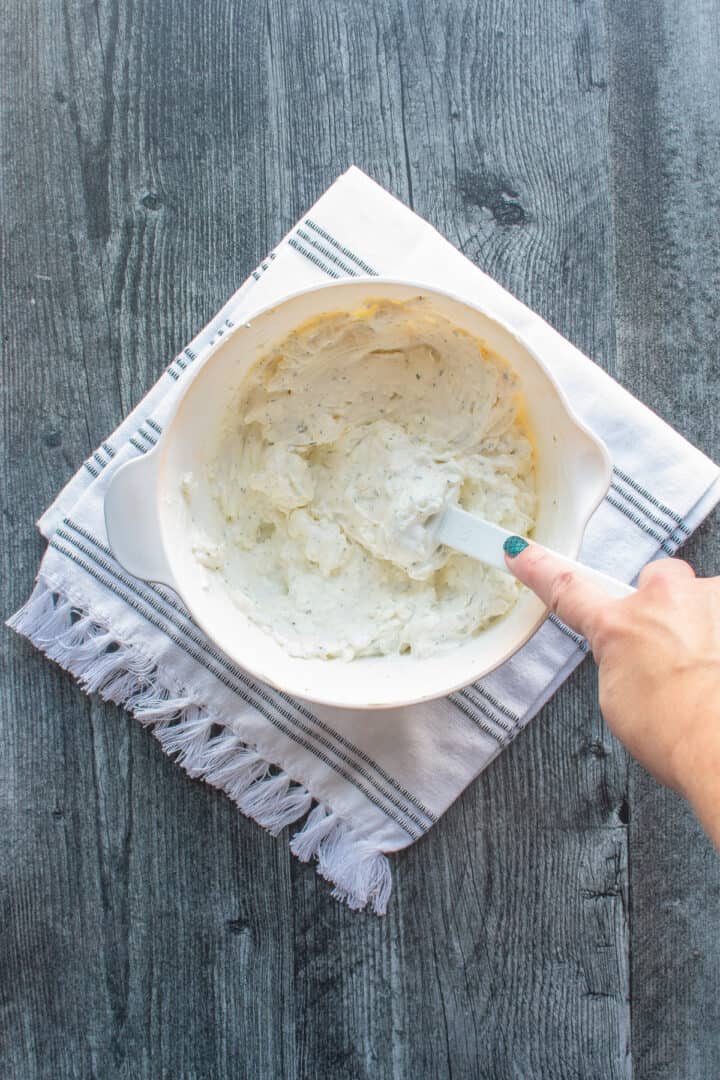 mixing cream cheese, ranch dressing mix and sour cream in bowl