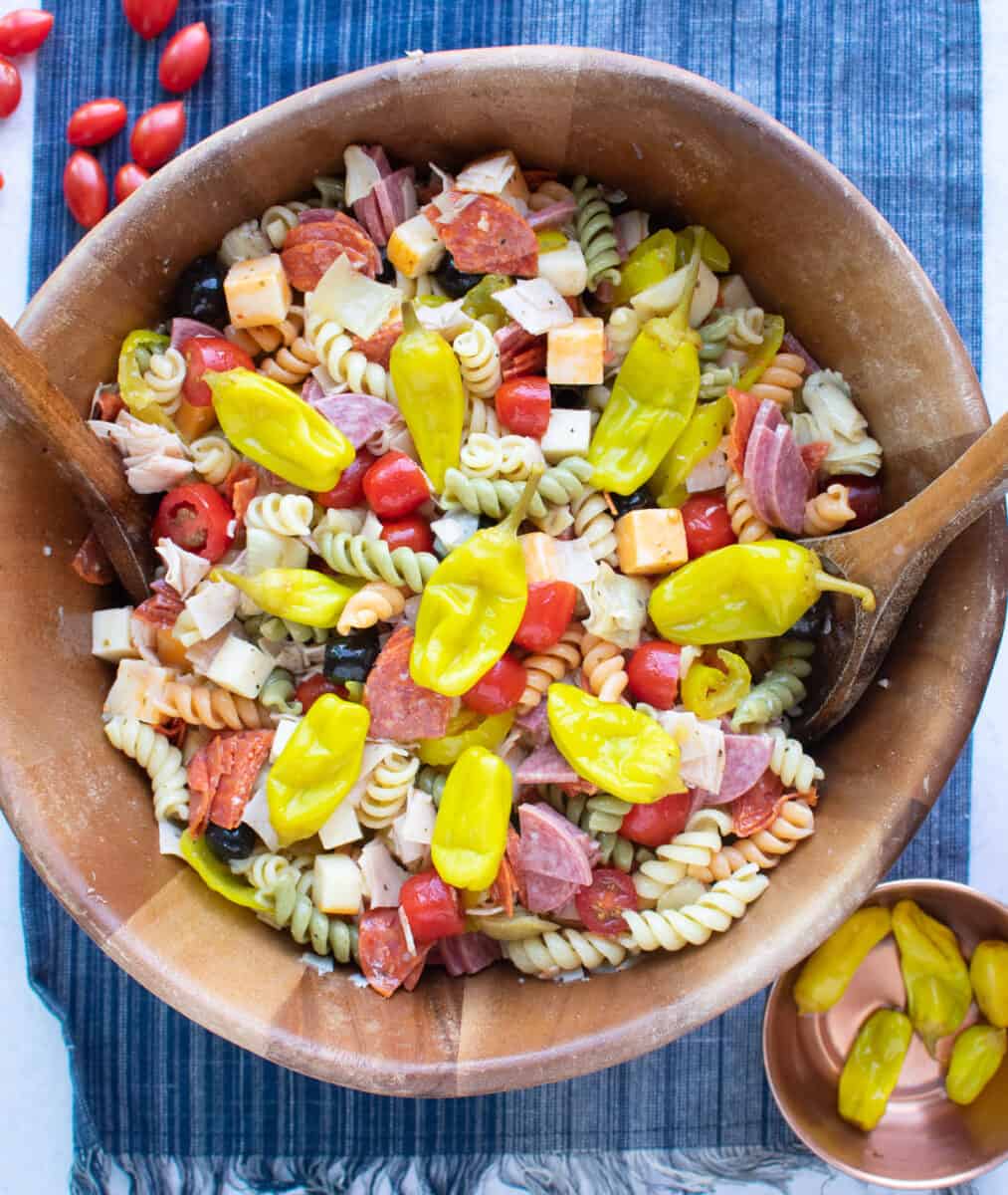 easy pasta salad in large bowl topped with pepperoncini peppers