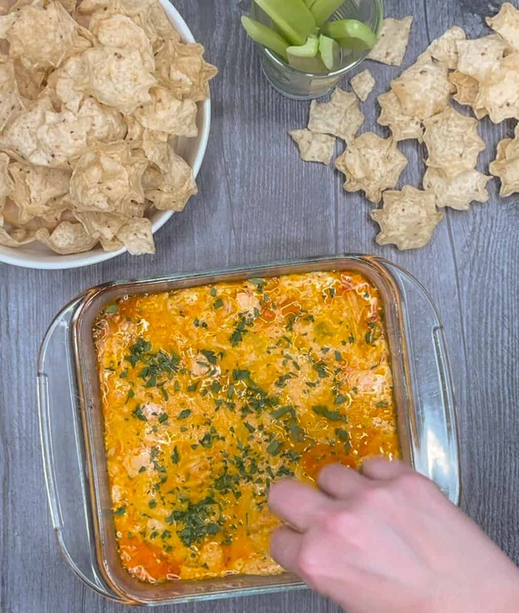 sprinkling on chopped italian parsley on top of baked buffalo chicken dip