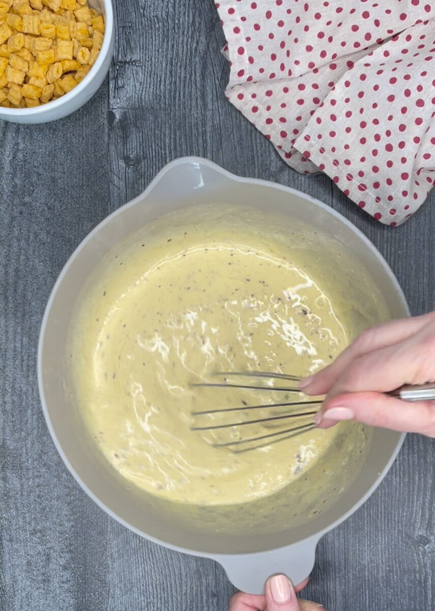 whisking eggs and other ingredients in mixing bowl