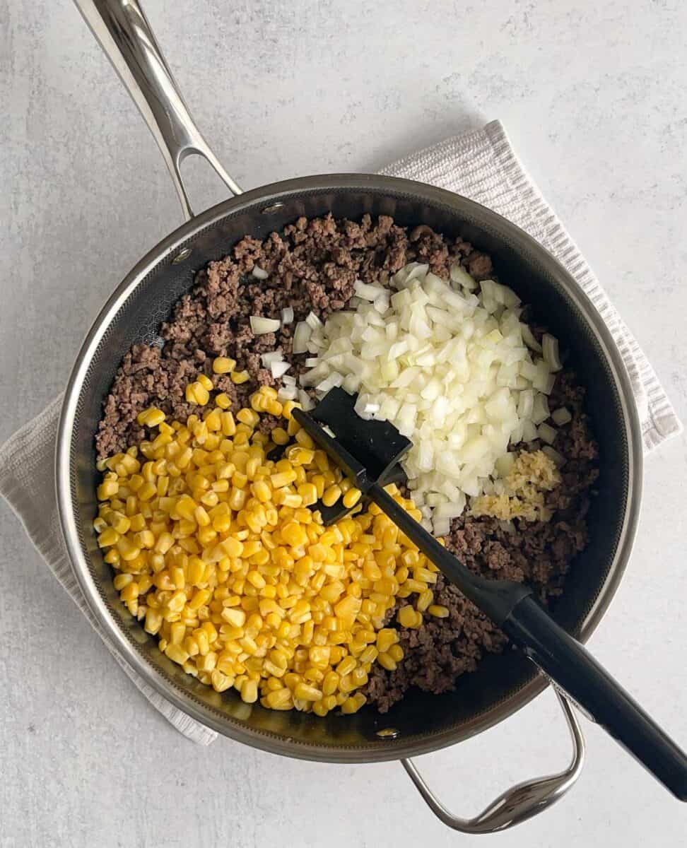 step 3 add corn and onions to beef in pan