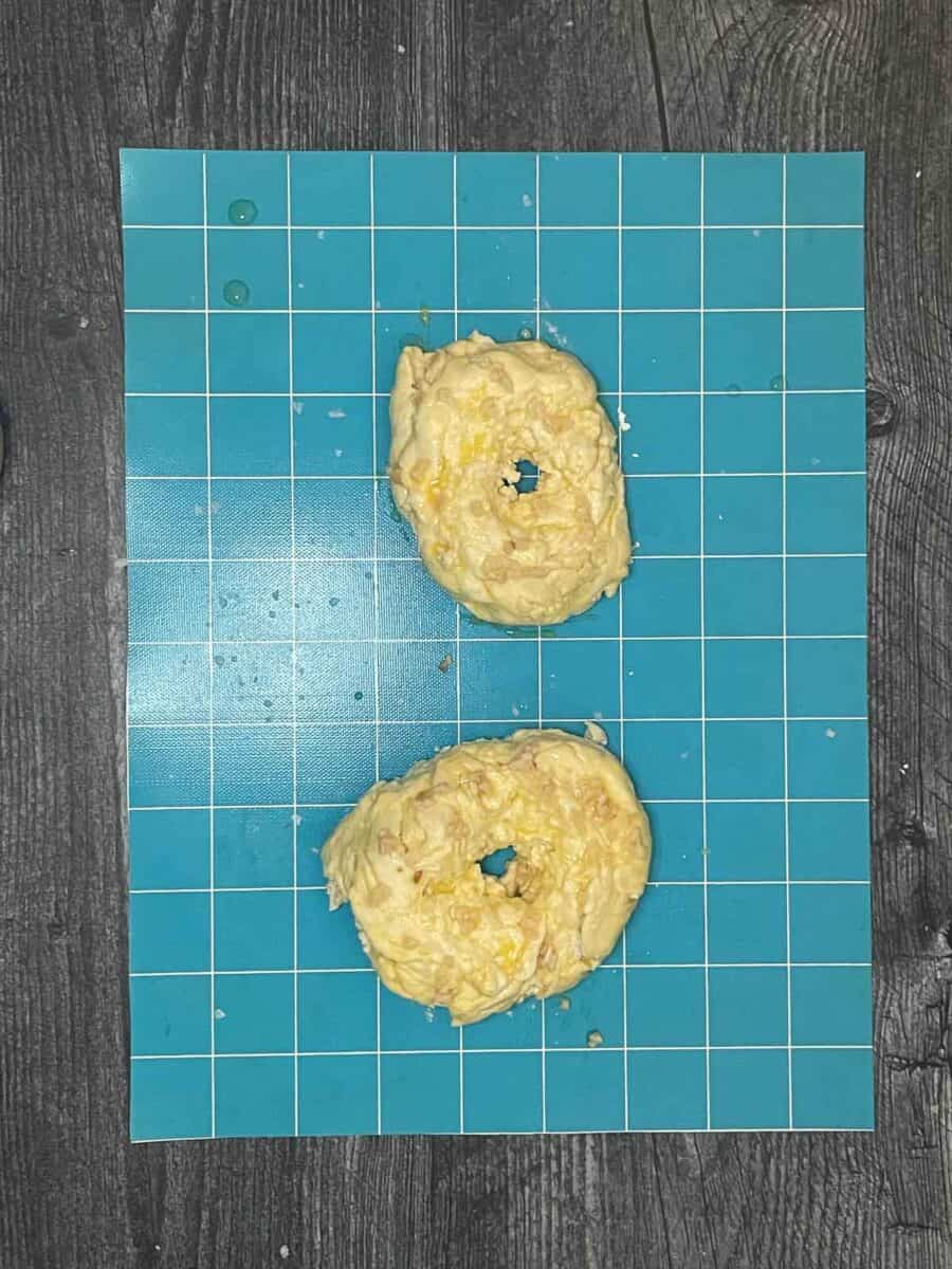 formed raw cottage cheese bagel dough on a silicone mat