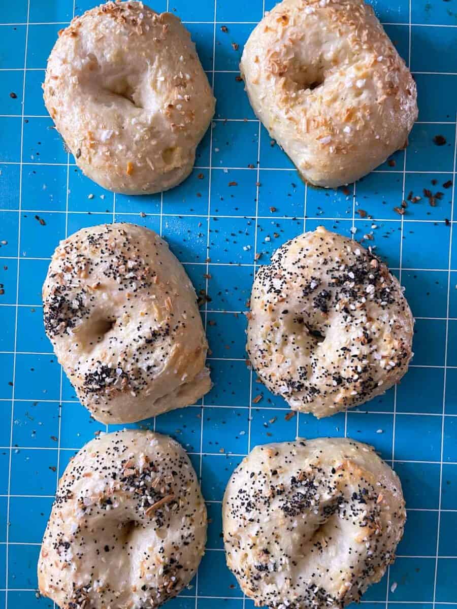 overhead view of baked bagels right out of the oven on a silicone baking mat