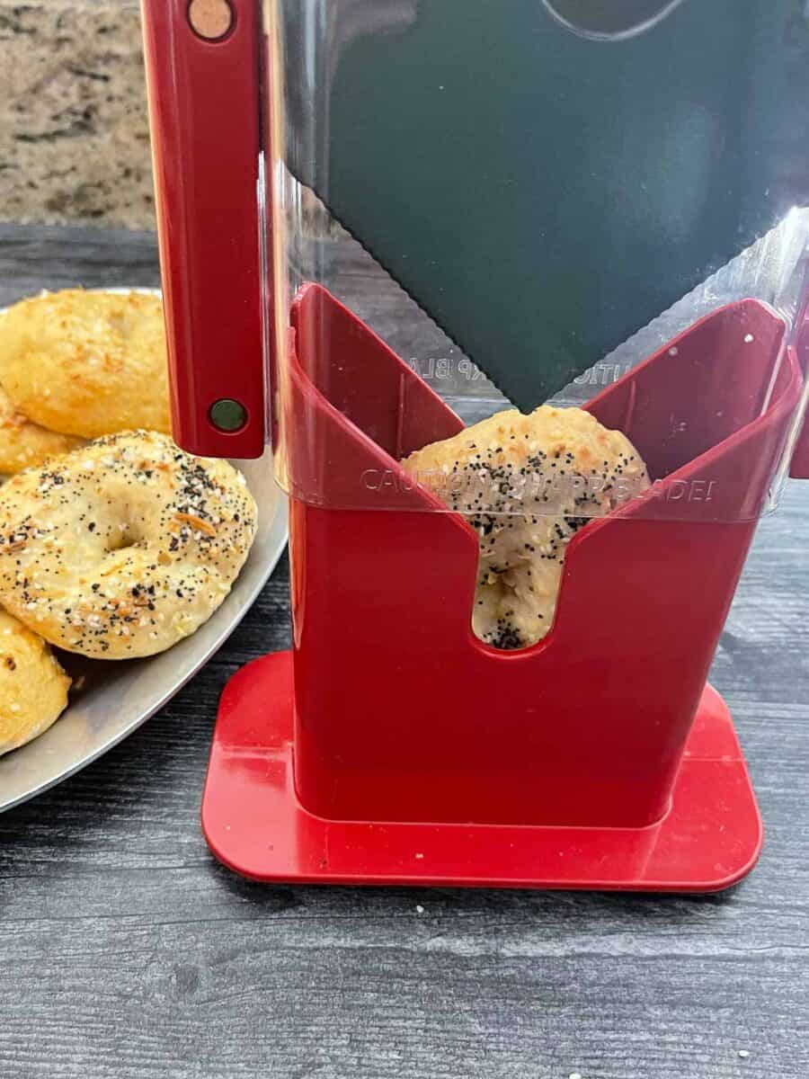 Bagel in a bagel slicer about to get cut
