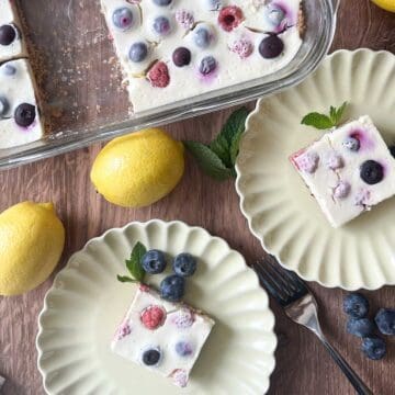 overhead view of cheesecake bars in dish and two slices on serving dishes