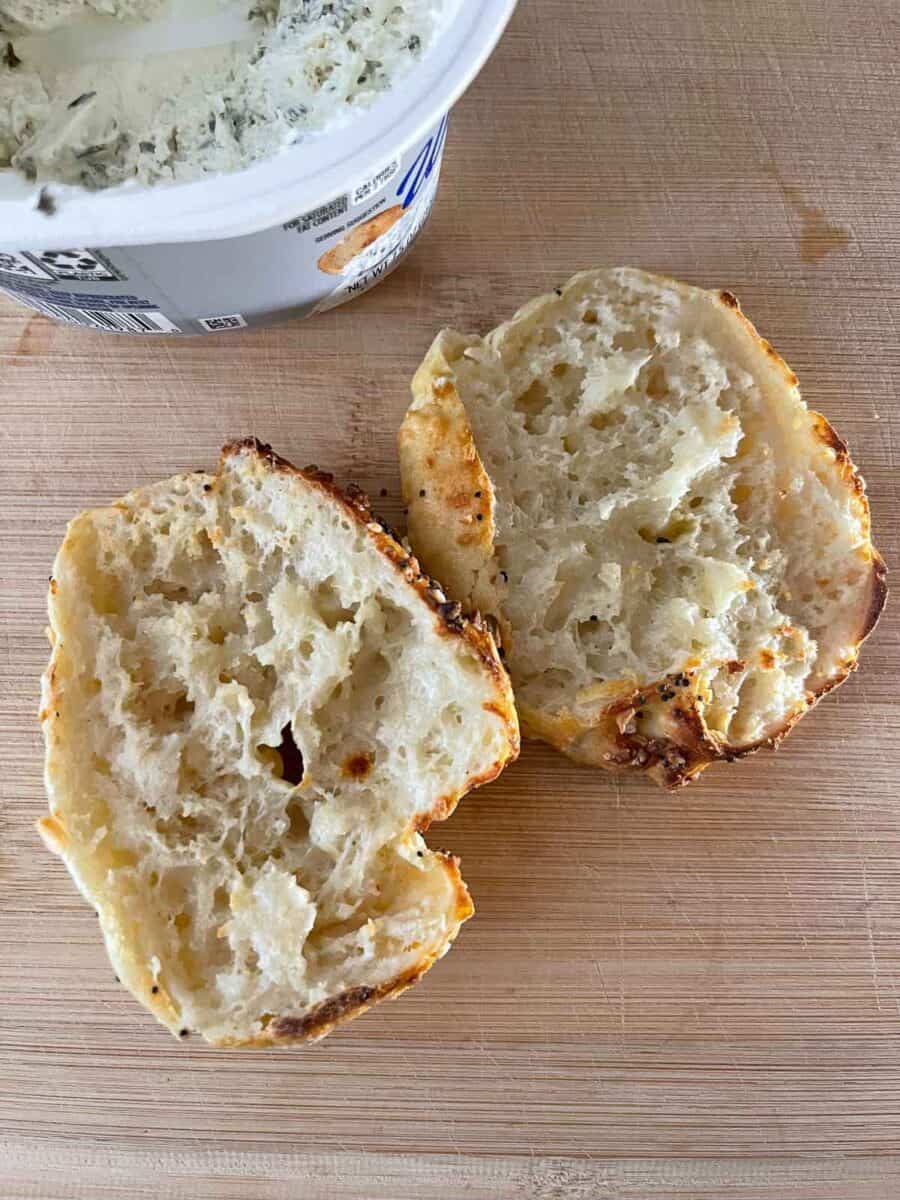 Baked cottage cheese bagel cut open on a cutting board