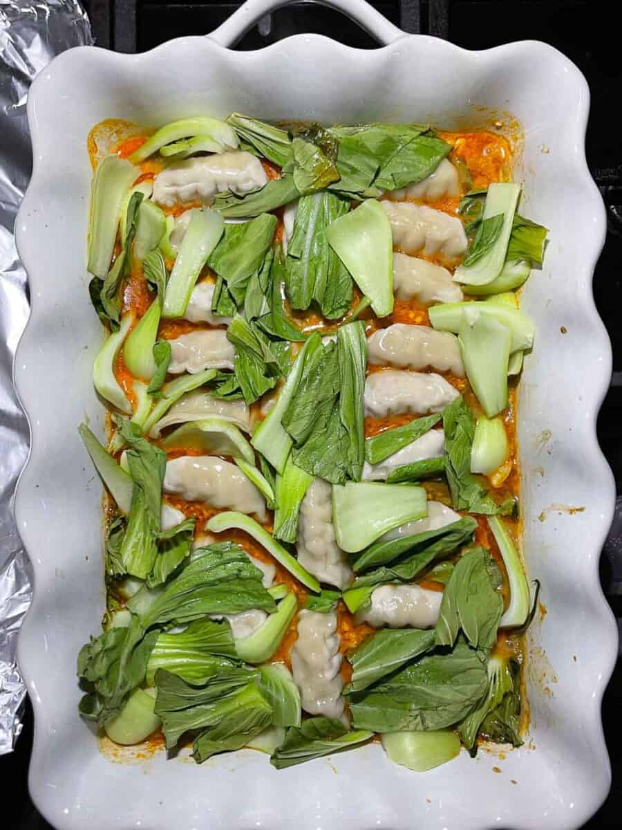 baked dumplings in white dish right out of the oven