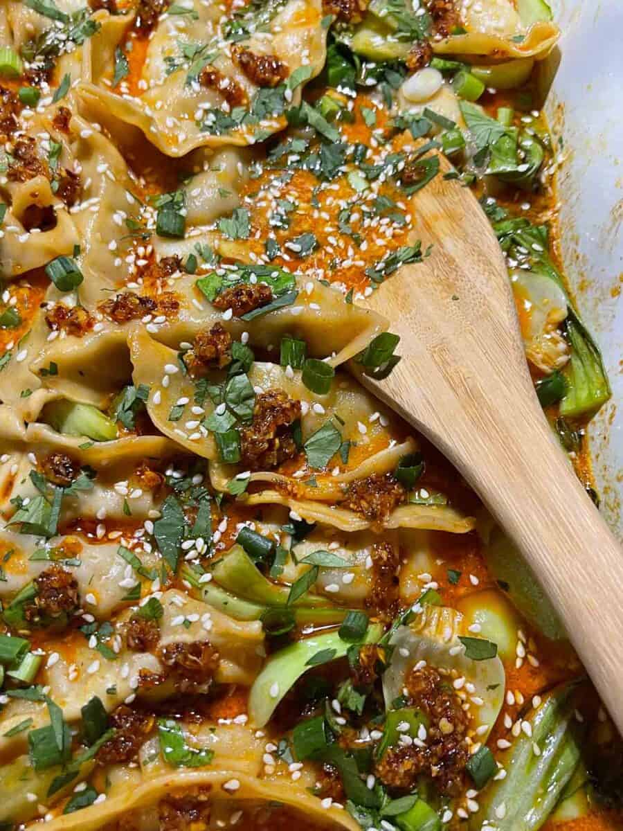 very closeup view of dumpling bake recipe in dish with wooden spoon