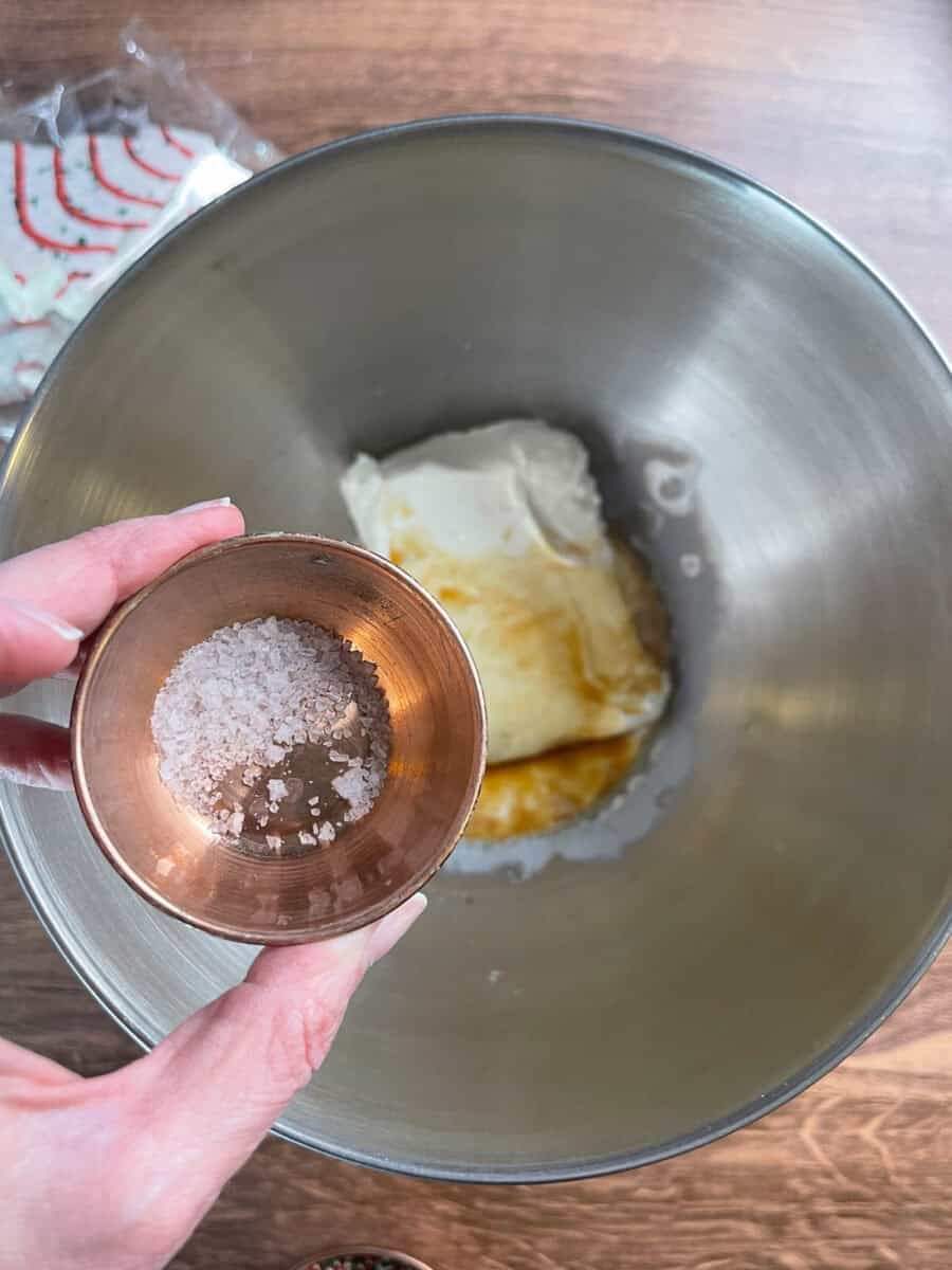 adding salt to mixing bowl