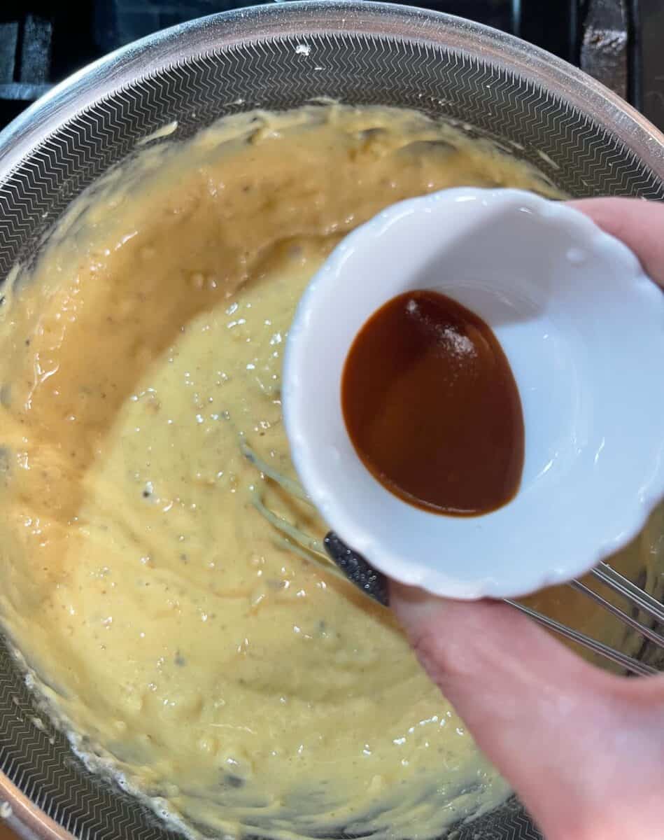 Adding a dash of hot sauce to the pot