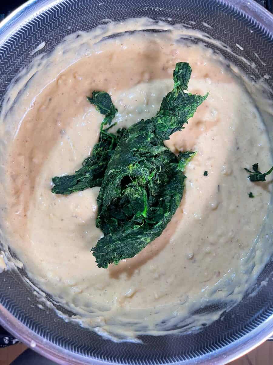 Adding spinach to the pot